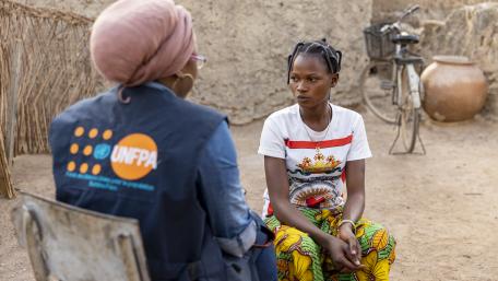 A humanitarian worker talks to a young woman