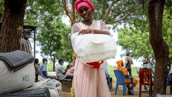 A young woman carries non-food items