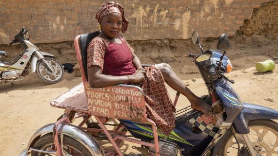 A disabled woman sits on her motorcycle