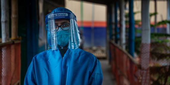 A health worker wearing a protective shield mask